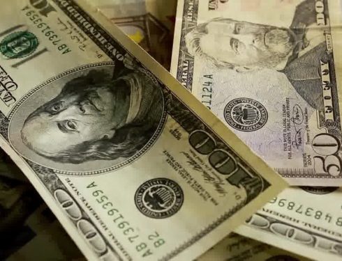 a pile of twenty dollar bills sitting on top of each other